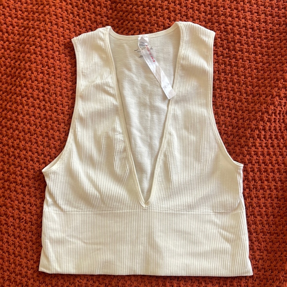 Out from under white ribbed crop top